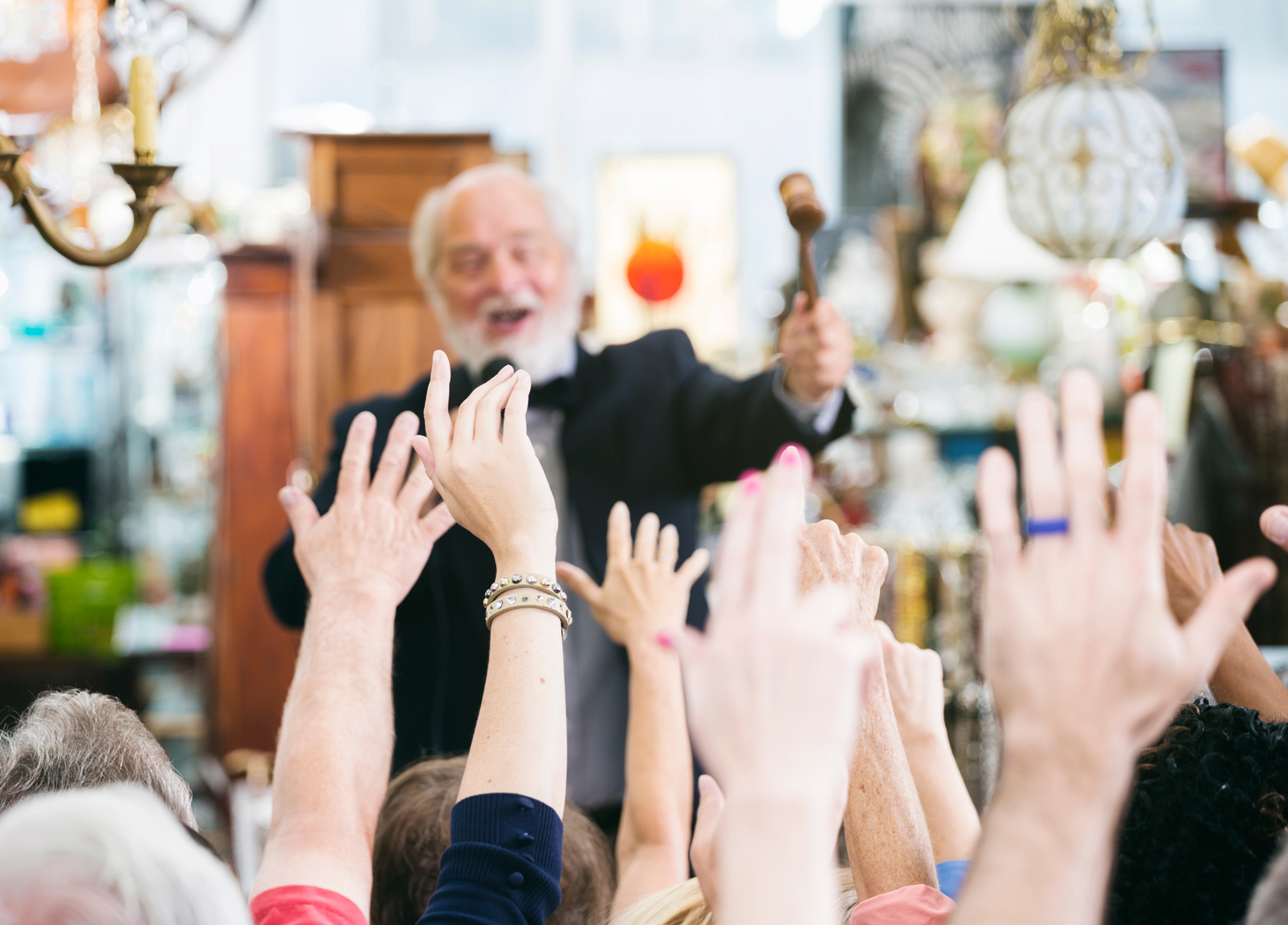 Auctioneer with Large Crowd of Buyers